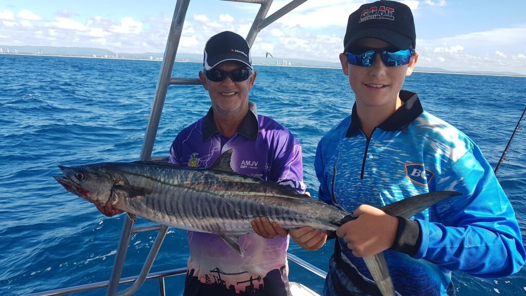 kids with a mackerel caught on Gold coast fishing charters