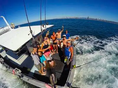 Happy angler with catch on Gold Coast afternoon fishing charter