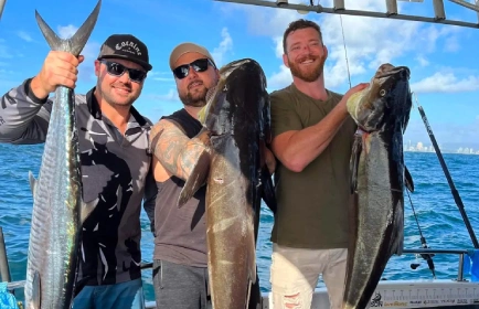 Mates showing off their fresh catch during a bucks party fishing trip Gold Coast