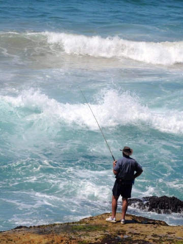 Man Fishing Beside Sea